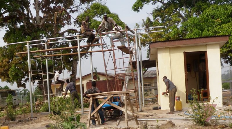 Team constructing scaffolding for a site structure