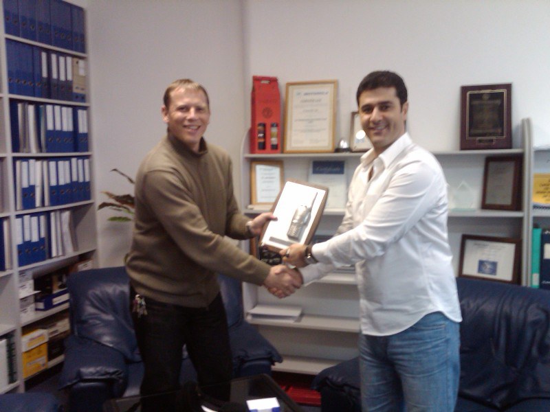 Sigma Communications team members meeting with a business partner
