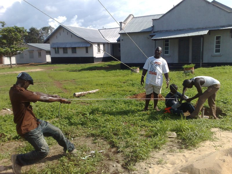 Team guying an antenna mast into position
