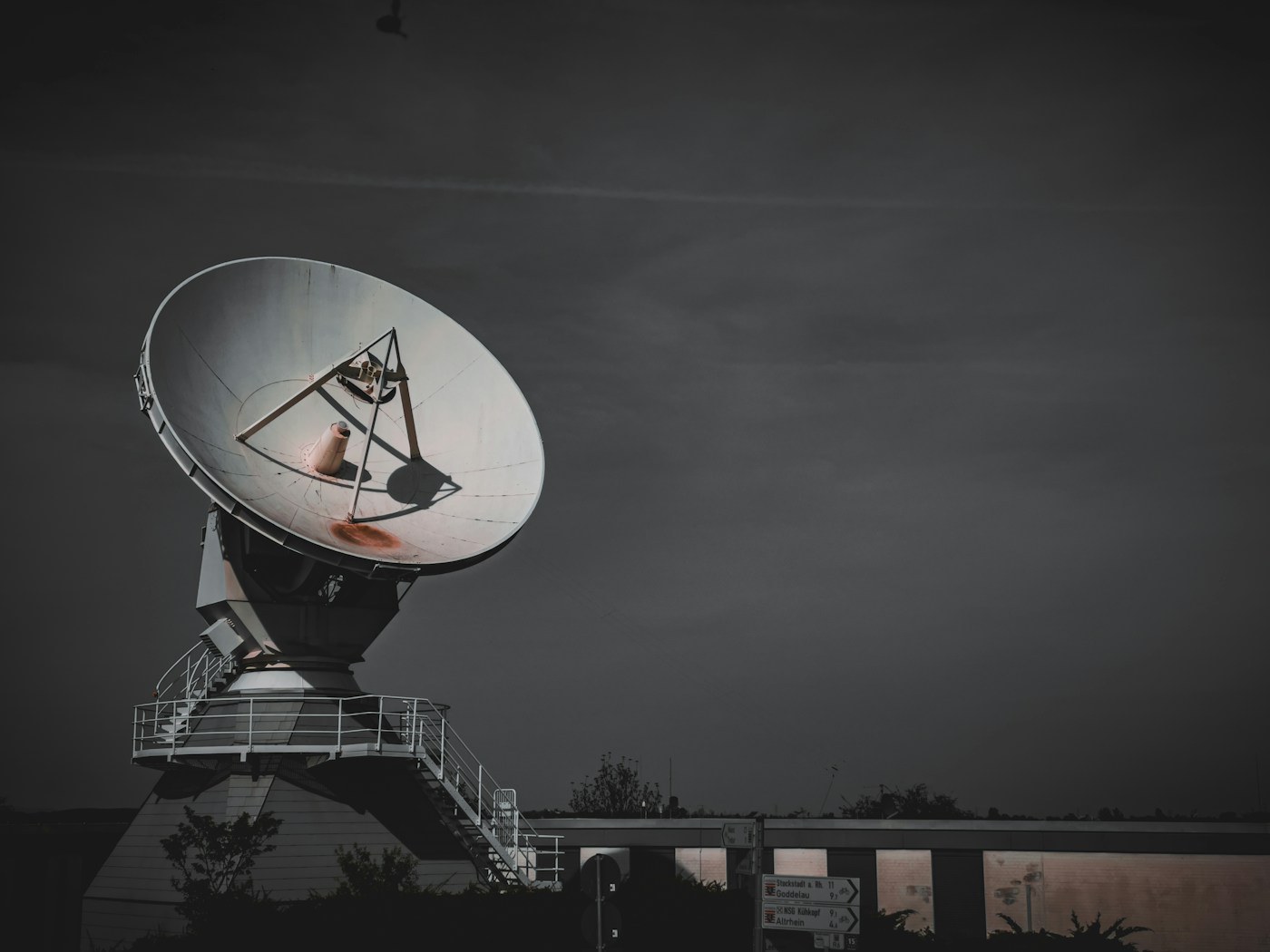 Large satellite dish antenna at dusk